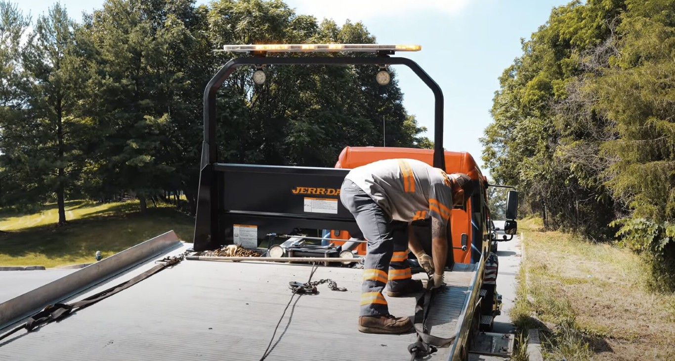 Professional towing service securing vehicle on flatbed in Laguna Niguel, CA